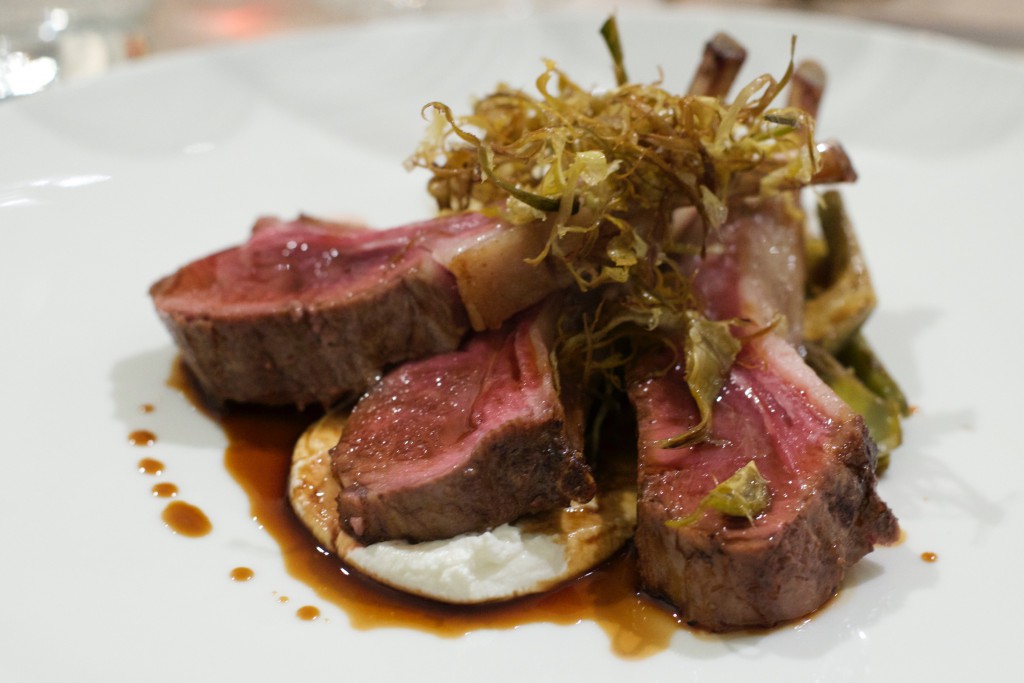 Roast rack of Spring lamb accompanied by artichokes and sitting on a dollop of robiola cheese.