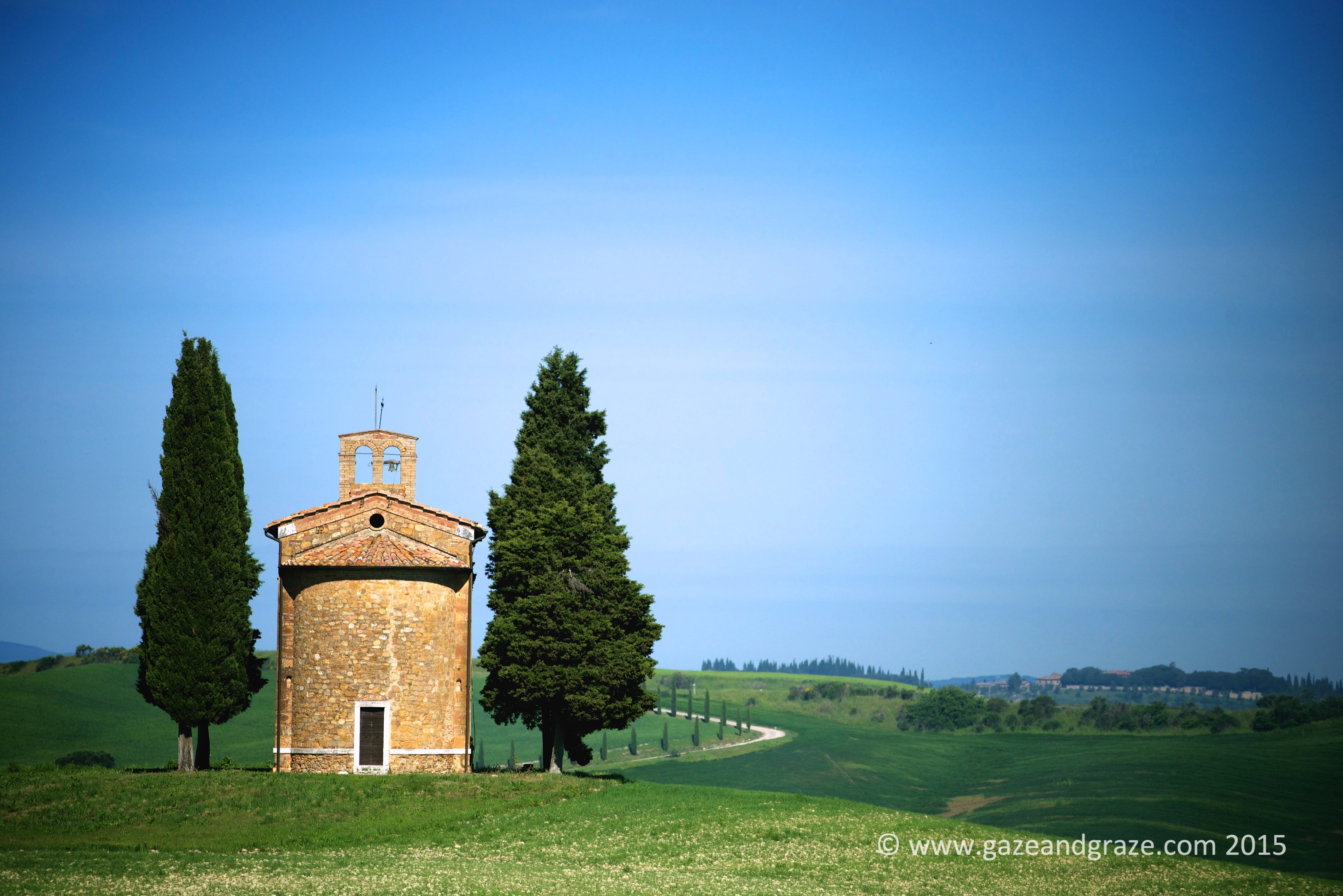 Iconic tuscan chapel with cypress trees