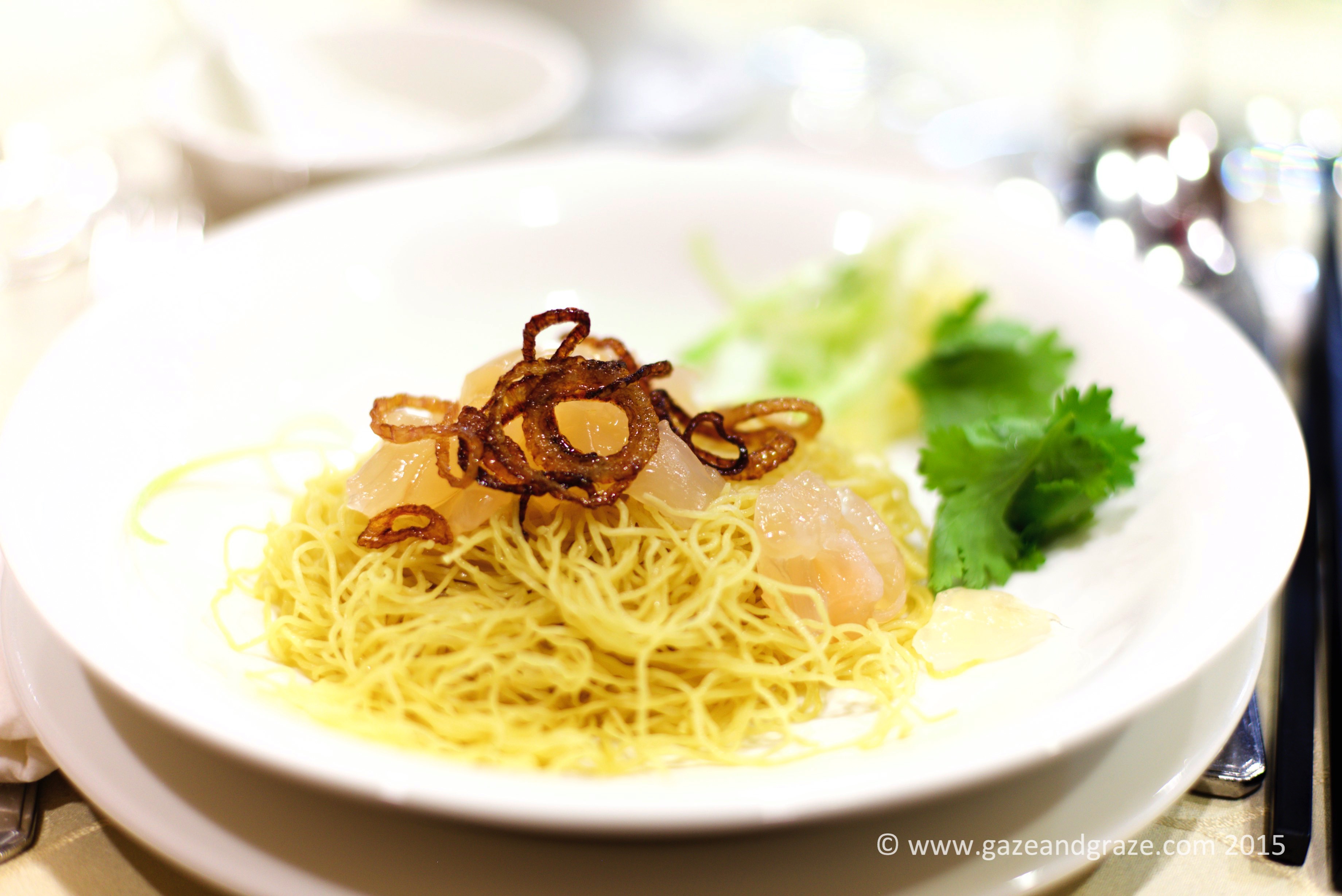 Noodles and lobster sashimi dressed with fried onions