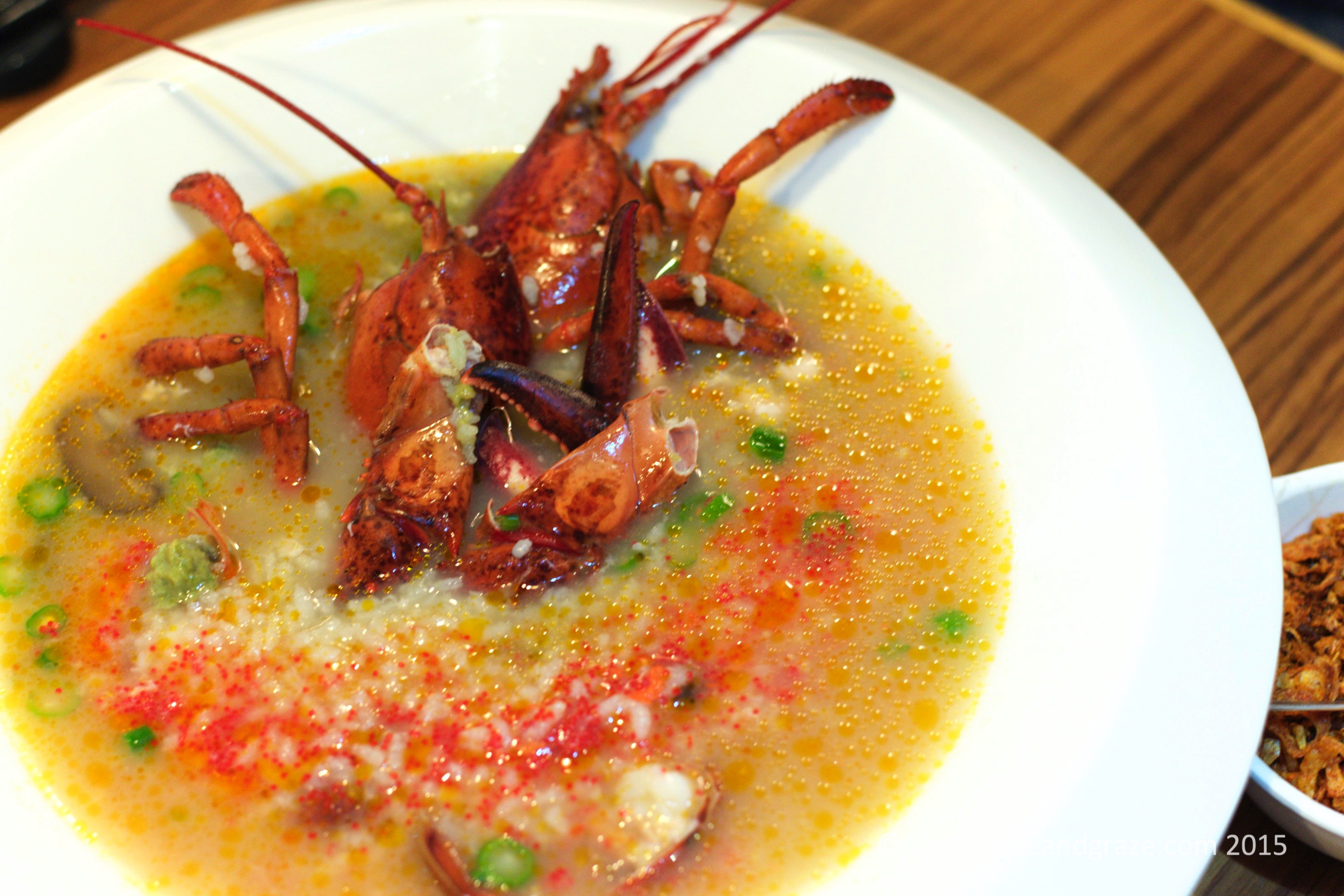 A whole lobster with rice in soup