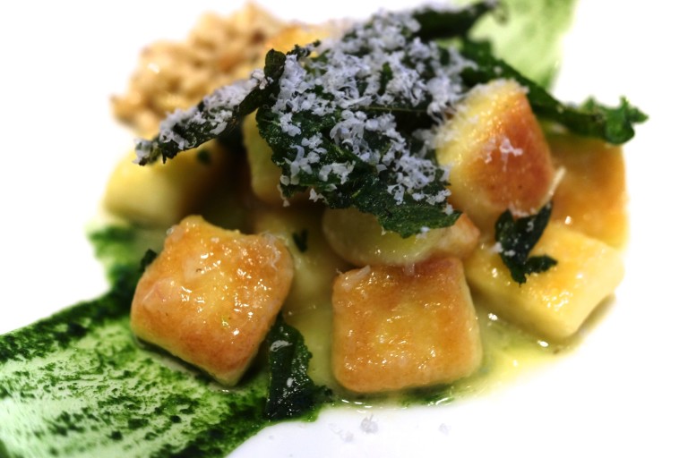 Semolina gnocchi with nettle and pine nuts