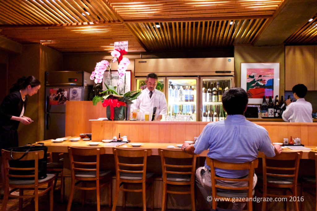 The sake master is behind the bar