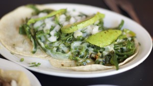Tacos with peppers, cheese and onions
